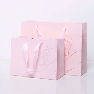 Luxury rose gold stamping printing pink handle bag, custom paper packaging bag with silk ribbon Handle paper gift bag